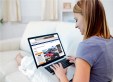 Woman browsing car listings on a laptop
