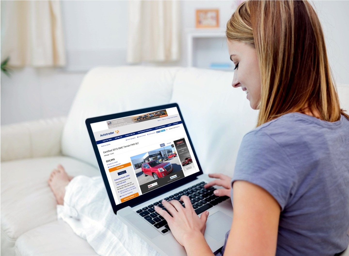 Woman browsing car listings on a laptop