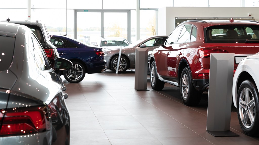 Vehicles in a high-end automotive dealer showroom.