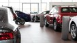 Vehicles in a high-end automotive dealer showroom.